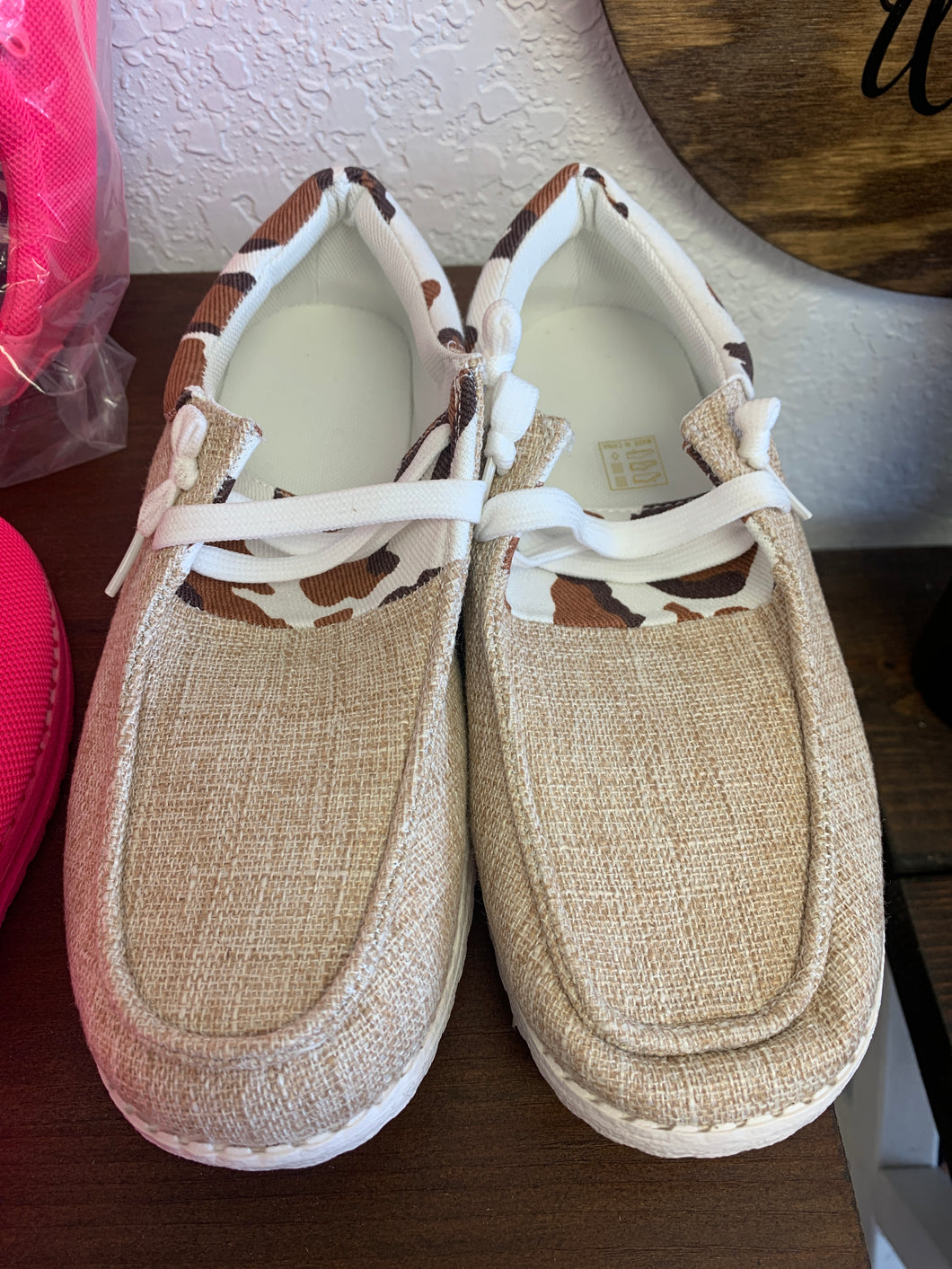 Tan and cow print slip on shoes